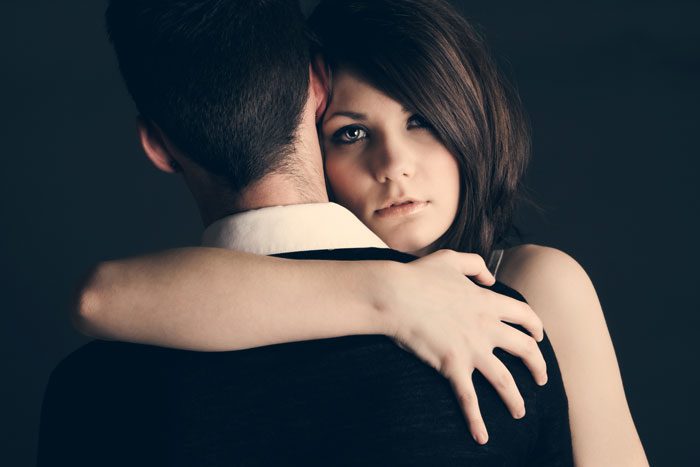 loving an addict - woman hugging man - victory addiction recovery center