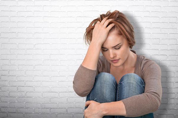 factors that contribute to drug addiction - depressed woman - victory addiction revocery center